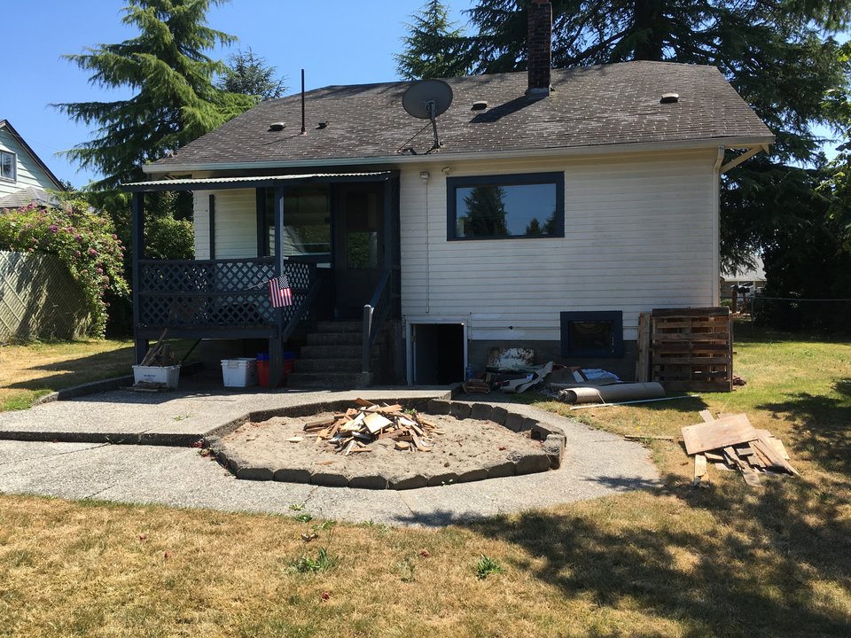 Photo of back of house with junk out